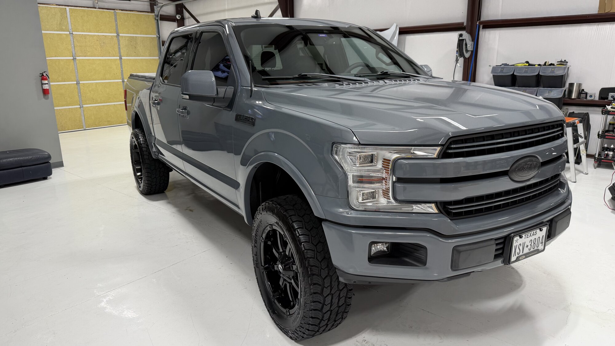 Gray lifted Ford F-150 after paint correction in the studio
