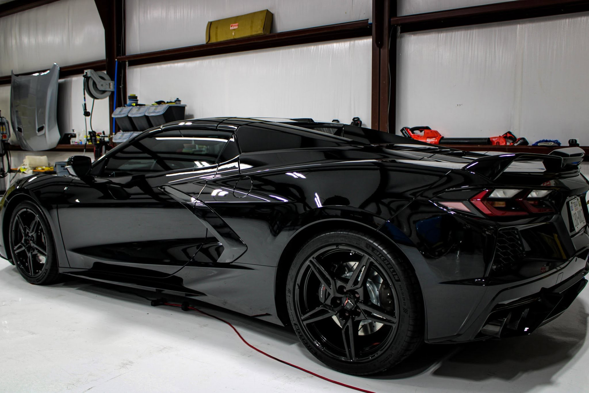 Black Corvette C8 Stingray with a mirror-gloss finish after full paint correction