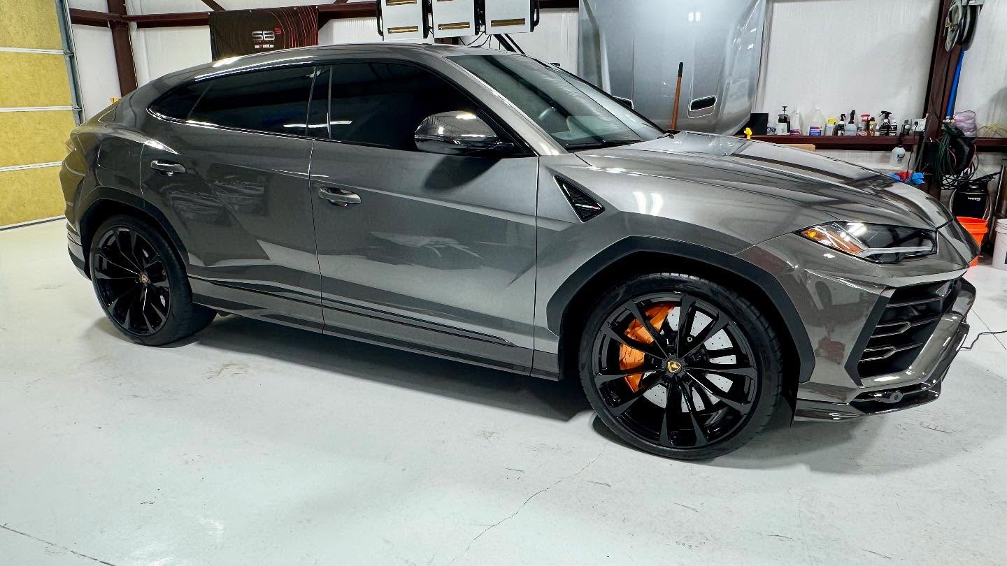 Gray Lamborghini Urus with refurbished gloss black wheels and orange calipers