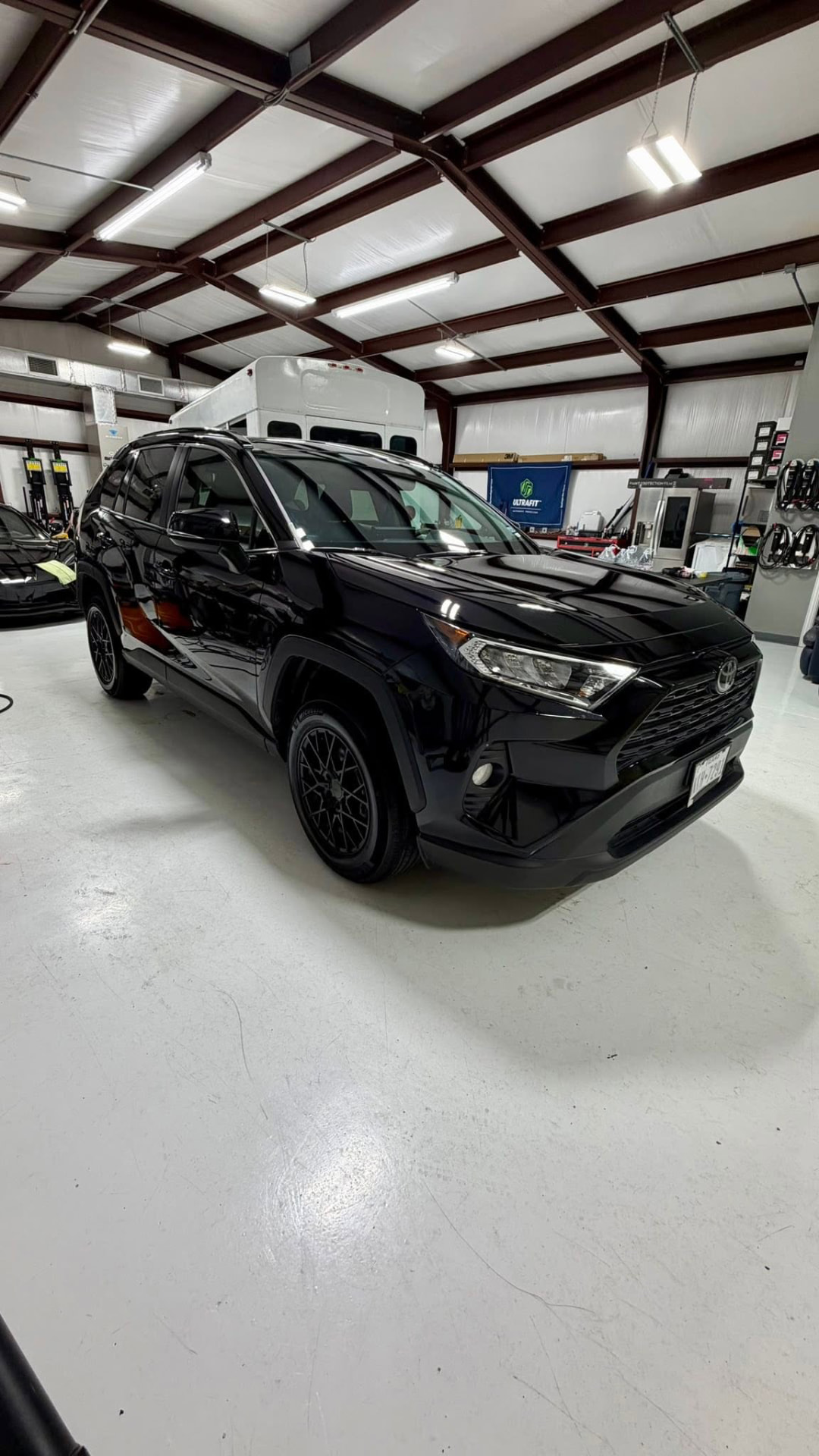 Black Toyota RAV4 XLE after a paint enhancement in the studio