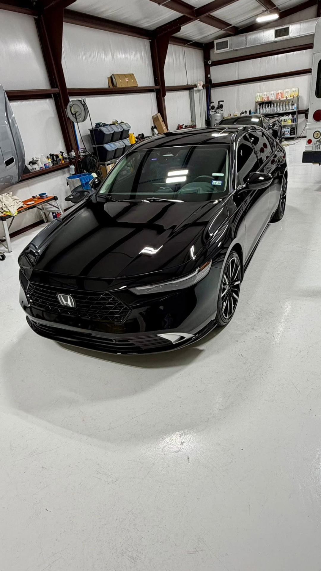 Black Honda Accord Hybrid Touring after paint correction in the studio
